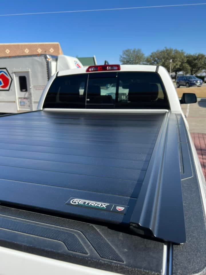 retractable bed cover on a white truck