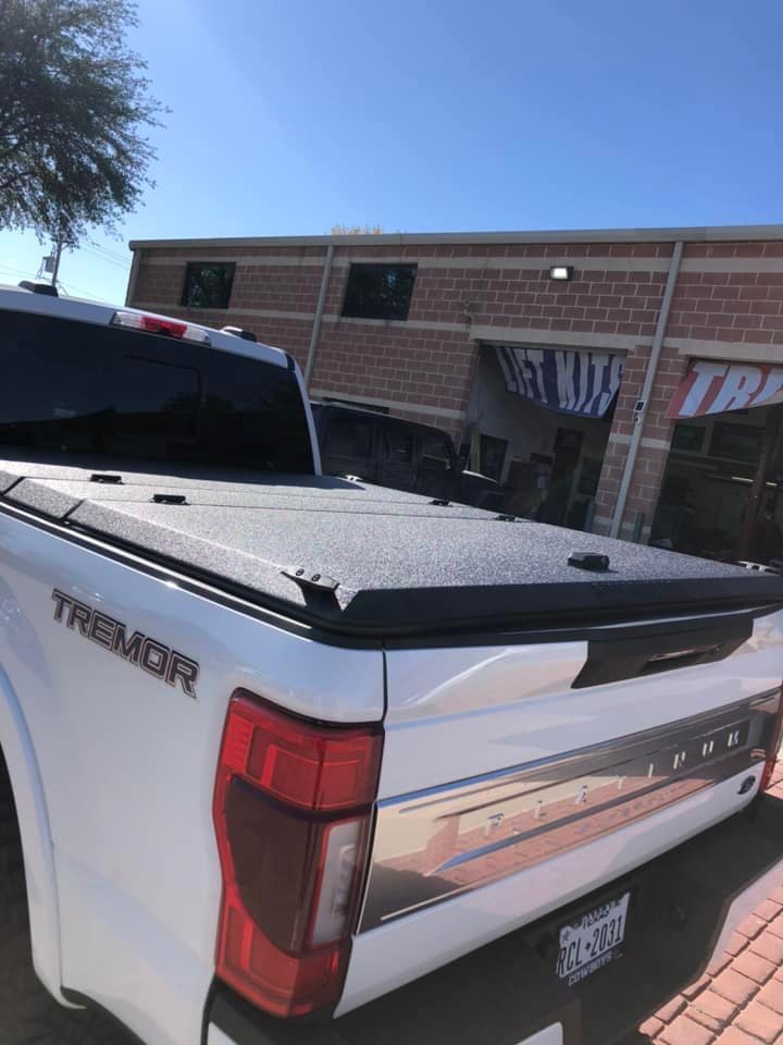 prop up hard top bed cover on a white truck